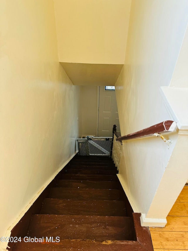 stairway featuring hardwood / wood-style flooring