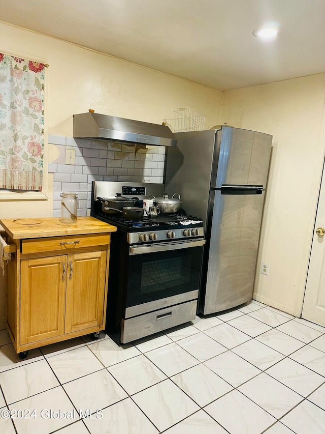 kitchen featuring extractor fan, stainless steel appliances, backsplash, and butcher block countertops