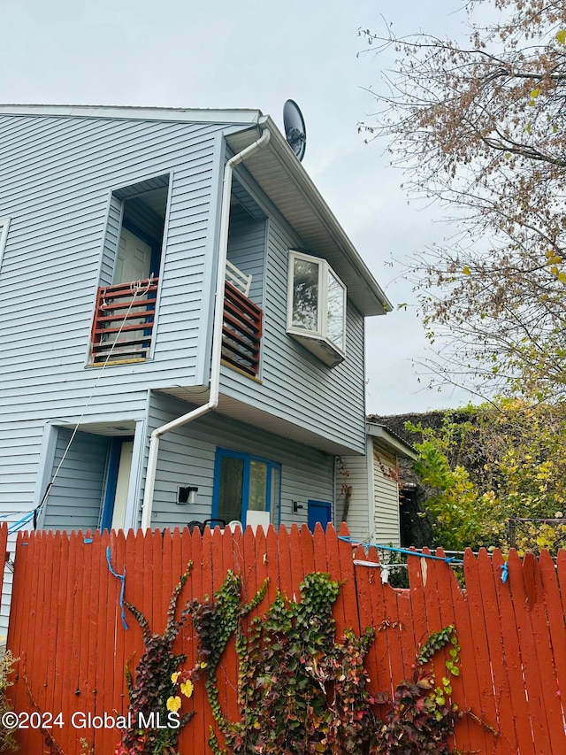 view of side of home featuring a balcony