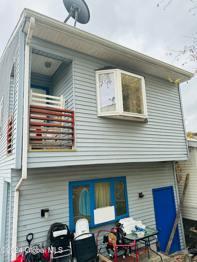 back of house featuring a balcony