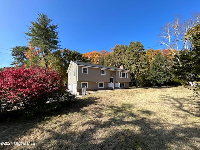 rear view of house with a yard