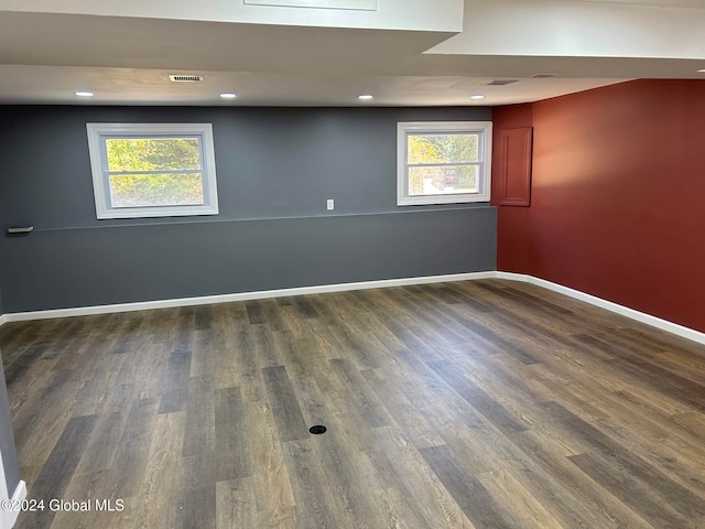 unfurnished room with dark wood-type flooring