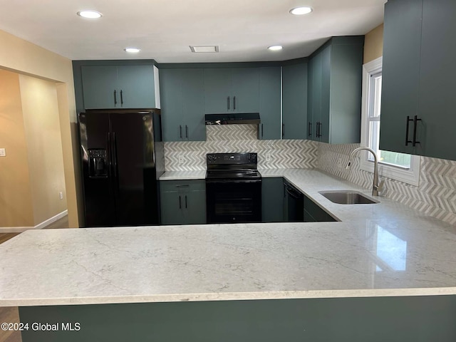 kitchen with backsplash, black appliances, sink, and kitchen peninsula