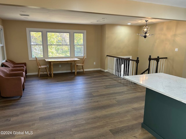 interior space featuring a chandelier and dark wood-type flooring