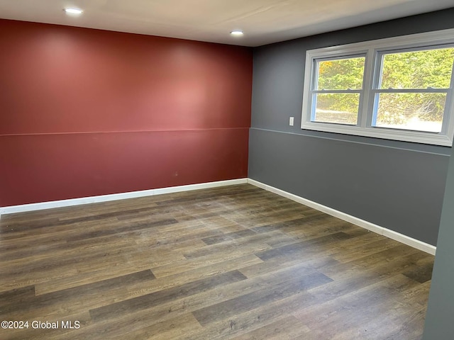 spare room featuring dark wood-type flooring