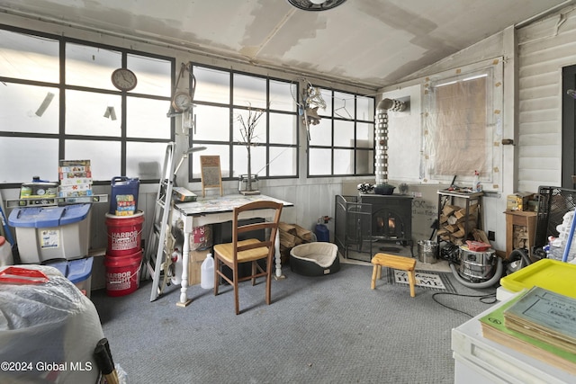 misc room featuring a wood stove and carpet floors