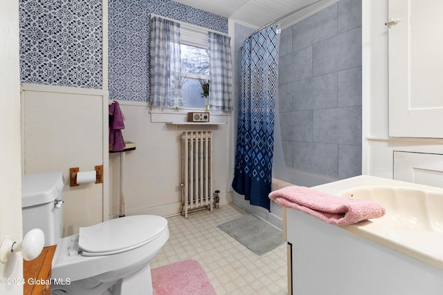 full bathroom featuring vanity, toilet, radiator heating unit, and shower / bath combo with shower curtain