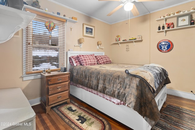 bedroom with ornamental molding, ceiling fan, and dark wood-type flooring