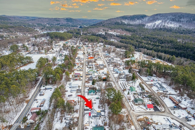 aerial view at dusk featuring a mountain view