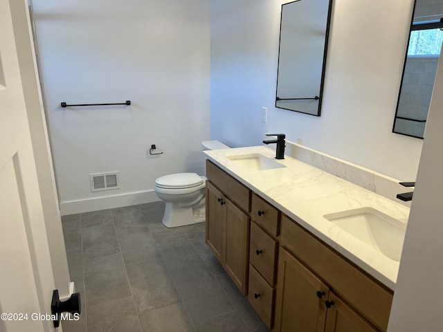 bathroom featuring vanity, toilet, and tile patterned flooring