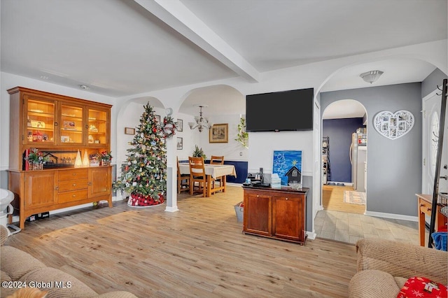 interior space with beam ceiling and light hardwood / wood-style floors