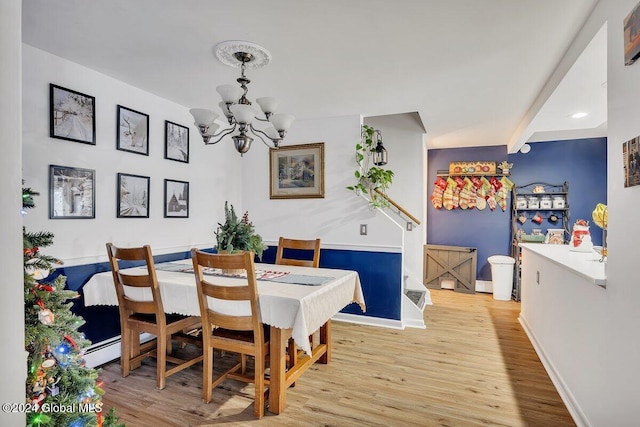 dining room with a chandelier and light wood-type flooring