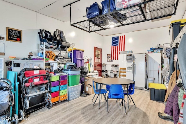 garage featuring white refrigerator with ice dispenser