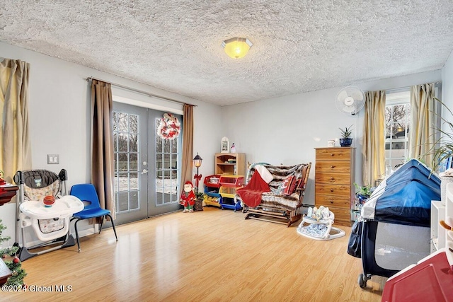 15 Windcrest Dr, Fort Edward, NY 12828 - recreation room with french doors, wood finished floors, and a textured ceiling