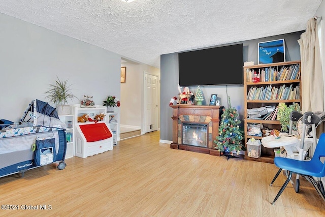 living area featuring light hardwood / wood-style floors and a textured ceiling