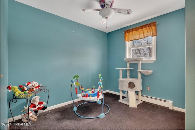 recreation room with carpet flooring, ceiling fan, and a baseboard heating unit