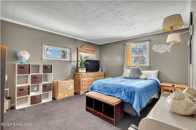 bedroom featuring dark carpet and a textured ceiling