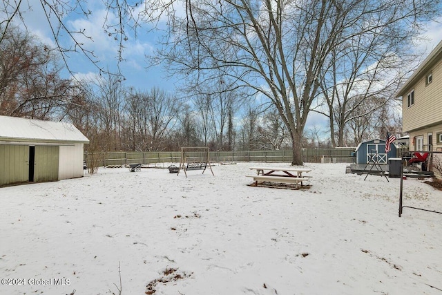 snowy yard with a storage unit