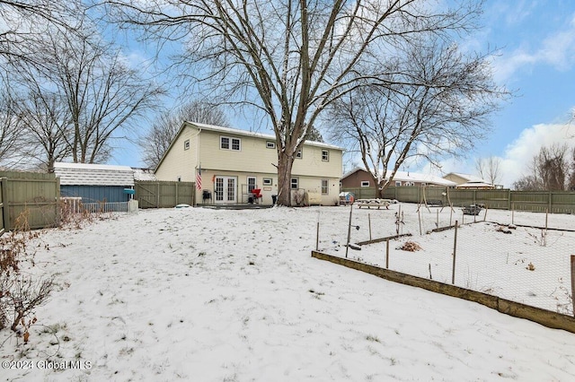 15 Windcrest Dr, Fort Edward, NY 12828 - snow covered back of property featuring a fenced backyard and french doors