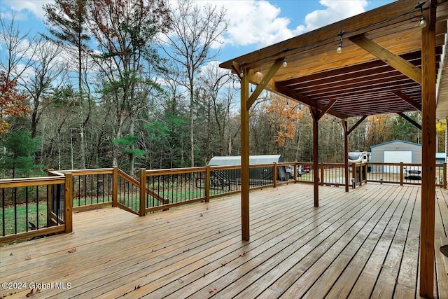 wooden terrace featuring an outdoor structure