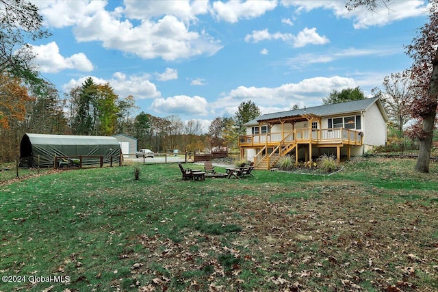 view of yard with a wooden deck and a carport