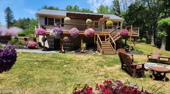 exterior space with a deck and a lawn