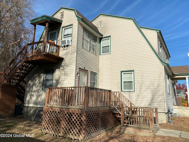 rear view of property with cooling unit