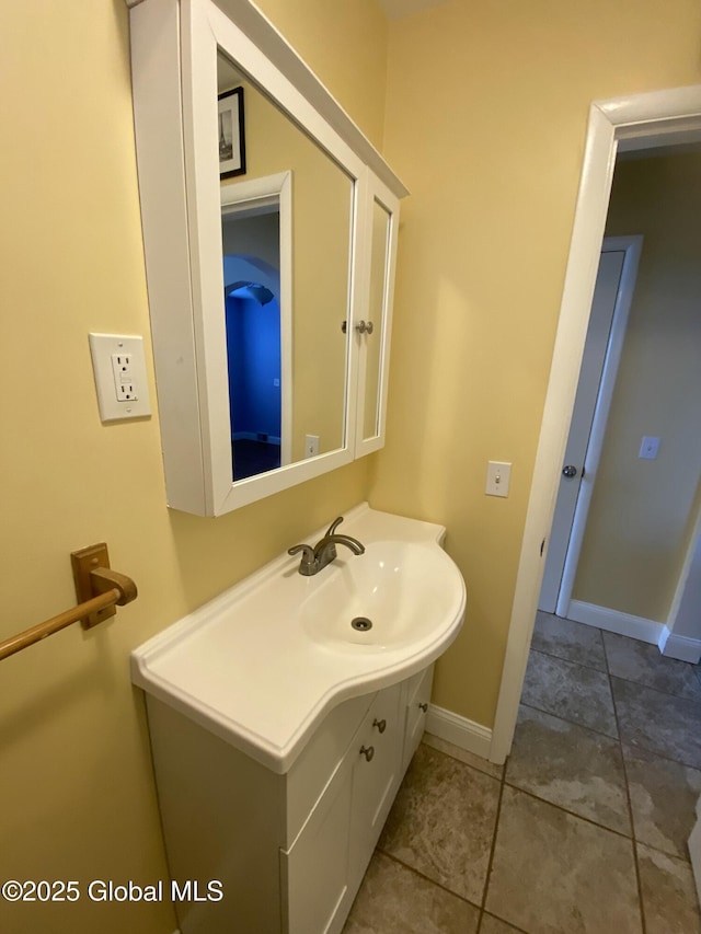 bathroom featuring tile patterned flooring, vanity, and baseboards