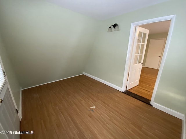 empty room featuring wood finished floors and baseboards