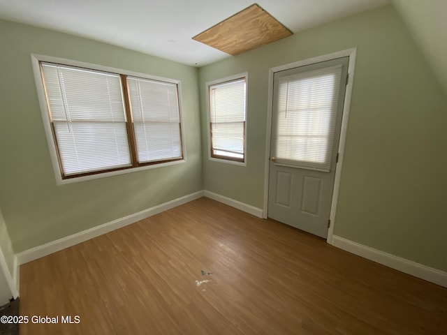 interior space featuring baseboards and wood finished floors