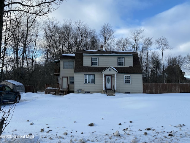 dutch colonial with a shingled roof, fence, and a chimney