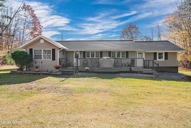 single story home with a front lawn and a deck