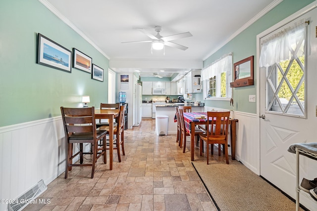 dining room featuring crown molding and ceiling fan