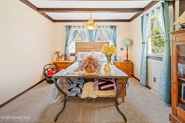 bedroom featuring light carpet and beamed ceiling