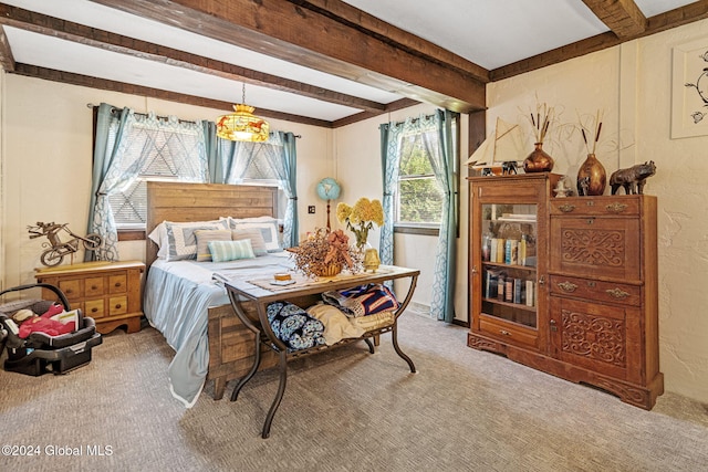 carpeted bedroom with beam ceiling