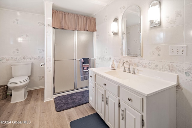 bathroom featuring vanity, tile walls, wood-type flooring, and toilet