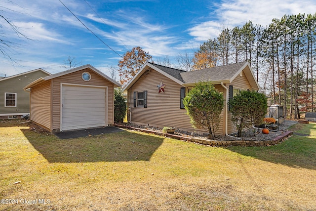 view of property exterior featuring an outdoor structure, a garage, and a lawn