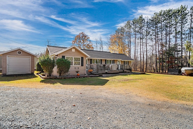 single story home featuring covered porch, an outdoor structure, a garage, and a front lawn