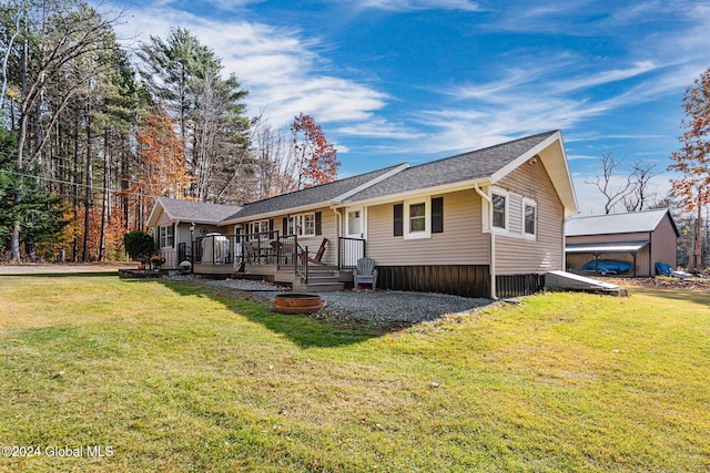 single story home featuring a wooden deck and a front lawn