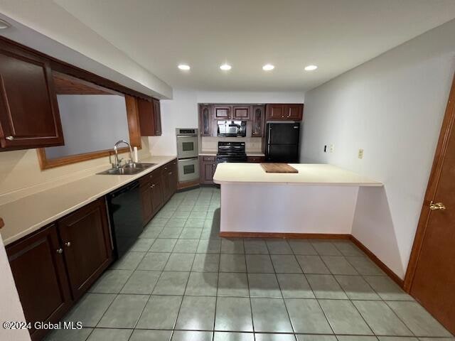 kitchen featuring black appliances, sink, dark brown cabinets, kitchen peninsula, and light tile patterned floors