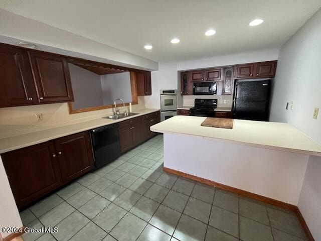 kitchen with black appliances, sink, kitchen peninsula, dark brown cabinetry, and light tile patterned floors