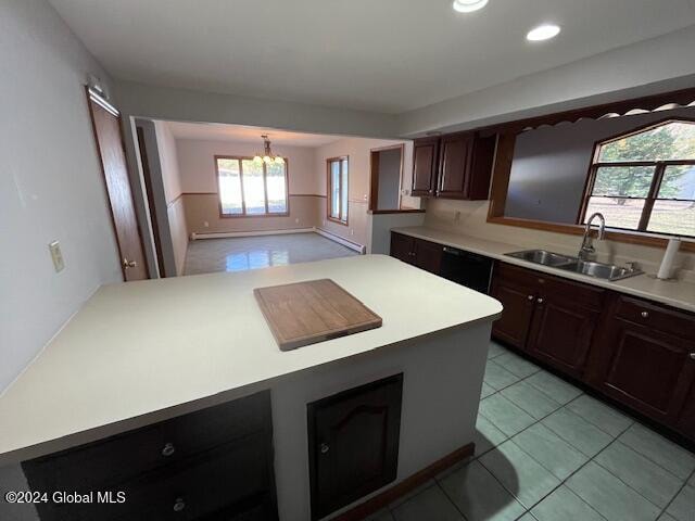 kitchen featuring an inviting chandelier, sink, light tile patterned flooring, and a kitchen island