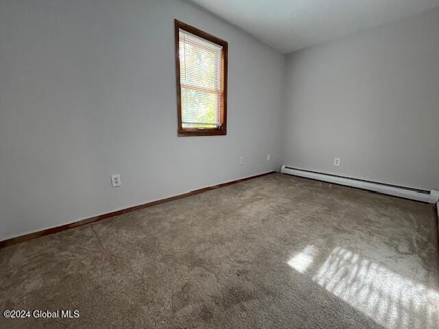 unfurnished room featuring carpet flooring and a baseboard radiator