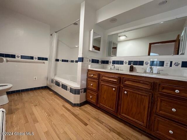 full bathroom featuring vanity, toilet, shower / bath combo with shower curtain, and wood-type flooring