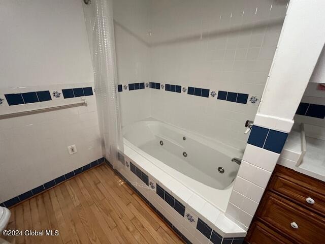 bathroom with shower / bath combo and wood-type flooring