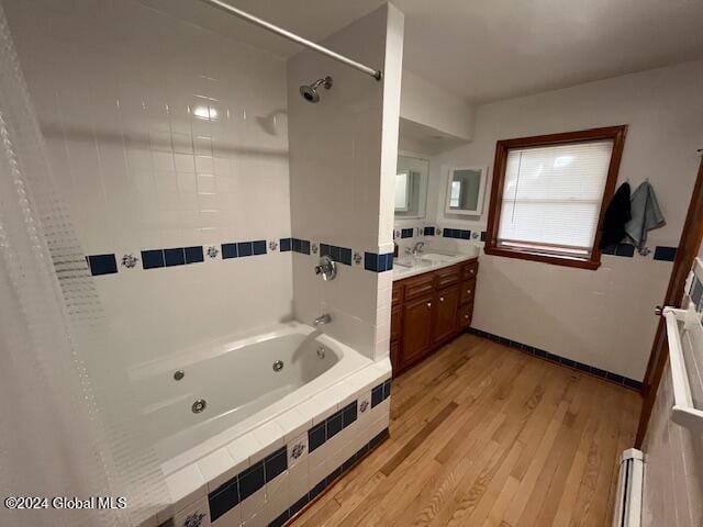 bathroom featuring vanity, hardwood / wood-style flooring, and baseboard heating