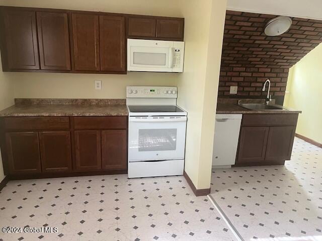 kitchen with white appliances, dark brown cabinets, and sink