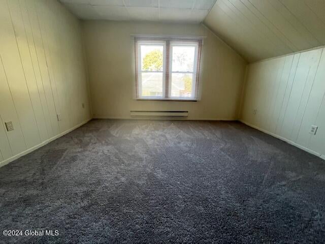 bonus room featuring lofted ceiling, baseboard heating, and dark carpet