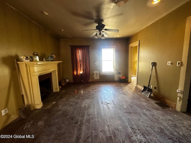 unfurnished living room featuring dark hardwood / wood-style flooring and ceiling fan