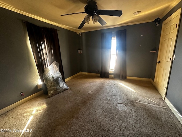 spare room with carpet flooring, ceiling fan, and crown molding